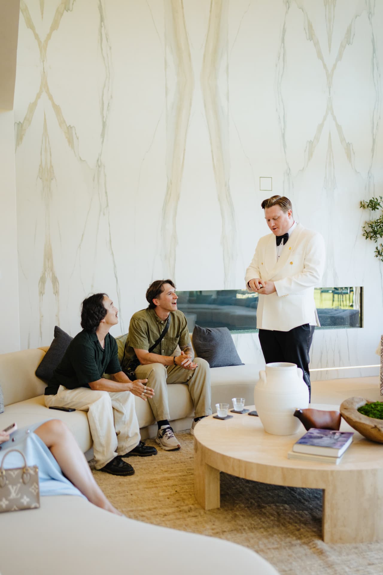White Rabbit LA magician in a white dinner jacket performing for wedding weekend guests in a luxury living room