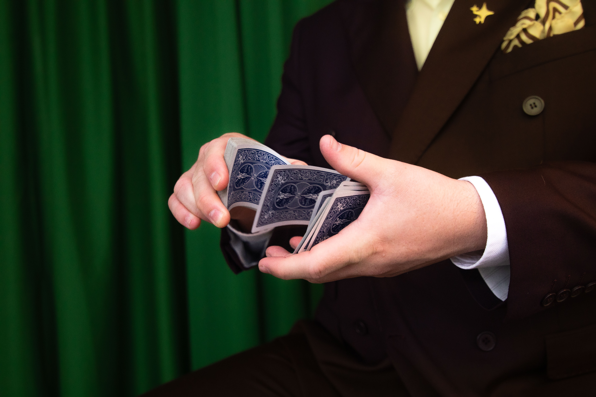 Close-up of Scott Syme shuffling cards before a private event performance
