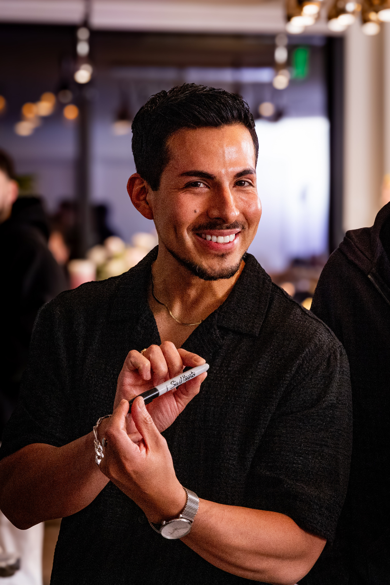 Wedding guests reacting with delight to close-up magic