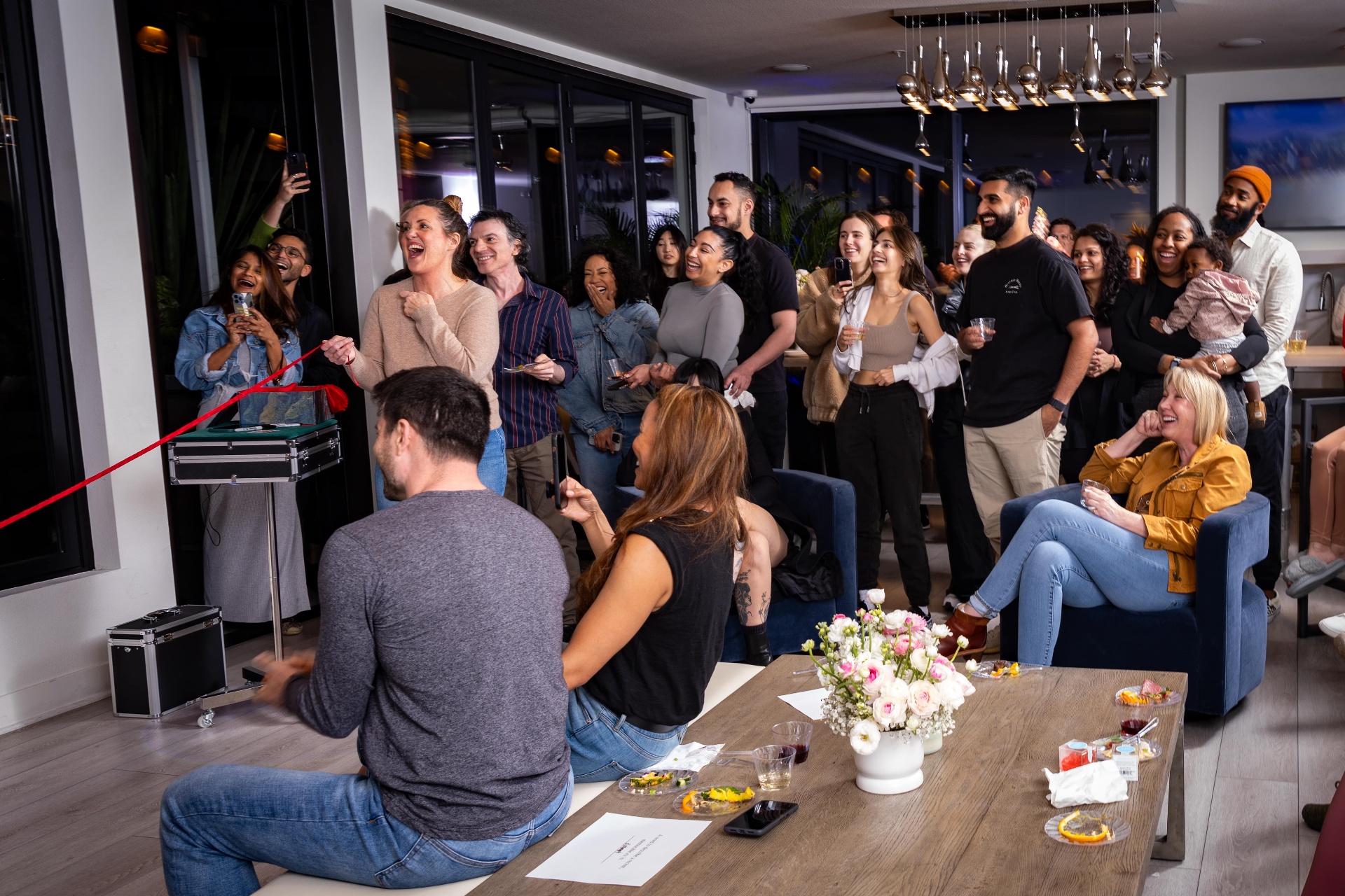 Scott Syme private magic show with emerald curtains and uplighting